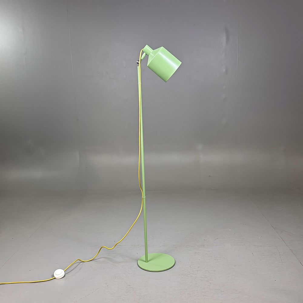 Begagnad golvlampa Silo från Zero i grönt med gul textilkabel. Mått: Diameter 15 cm, fot 25 cm, höjd 134 cm. 