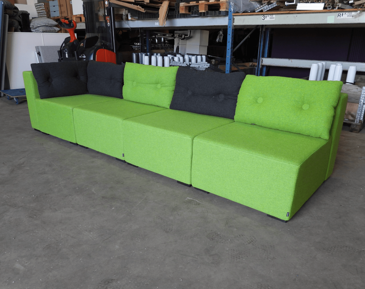 Begagnad modulsoffan Monolog från Materia är klädd i grön textil, med kuddar i grönt och grått. Mått: Bredd 300 cm, djup 90 cm, höjd 65 cm, sitthöjd 38 cm.  
