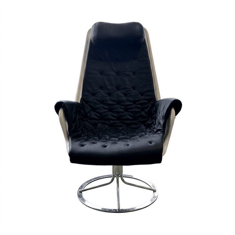 Begagnad fåtölj Jetson från DUX i svart läder med vit stomme. Mått: höjd 97 cm, bredd 65 cm och djup 83 cm.  