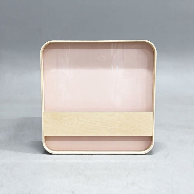 Begagnad glastavla Bloc från Lintex i rosa med inbyggt tidningsställ och ram i ask. Mått: Bredd 60 cm, Djup 5 cm, Höjd 60 cm.