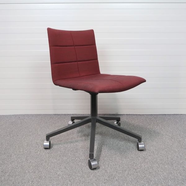 Stol med hjul Archal Low från Lammhults klädd i vinrött tyg, utan armstöd.