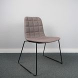 Stol Bop från Offecct på svarta medar klädd i brungrått tyg med insydda fyrkanter, utan armstöd.