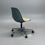 Begagnad Vitra Eames Plastic Side Chair PSCC med grått plastskal, ljusgul sittdyna, kromat underrede och hjul. Mått: Bredd 46,5 cm, djup 55 cm, höjd 76–88,5 cm. 