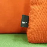 Begagnad fåtölj med hög rygg Mute från Mitab i grönt tyg, med orange kuddar från HAY. Mått: Bredd 77 cm, sittbredd 70 cm, djup 66 cm, höjd 130 cm, sitthöjd 45 cm. 