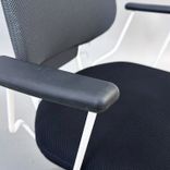 Begagnad konferensstol Invite från Savo med svart sits, mörkgrå rygg, vitt underrede och armstöd. Sitthöjd 41–52 cm. 