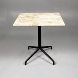 Begagnat cafébord från Audo Copenhagen med bordsskiva i beige/brun sten och svart pelarstativ. Mått: Bredd 60 cm, Djup 70 cm, Höjd 72 cm. 