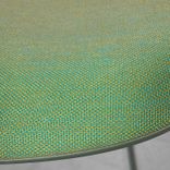 Begagnad barstol från Materia, modell Neo Lite. Stativ och skal i mörkgrön färg, helklädd sits i ett grönskimrande tyg med inslag av gult och orange. Mått: bredd 45 cm, djup 38 cm, höjd 84 cm sitthöjd 63 cm. 